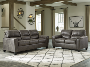 Upgrade to the modern Navi Sofa by Ashley Furniture. This 3-seater couch offers faux leather appeal in a Smoke finish with superior comfort. Durable design resists sagging. Find your new complete home furniture centerpiece.